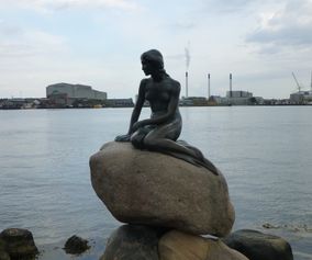 Cycling past the Little Mermaid in Copenhagen Denmark